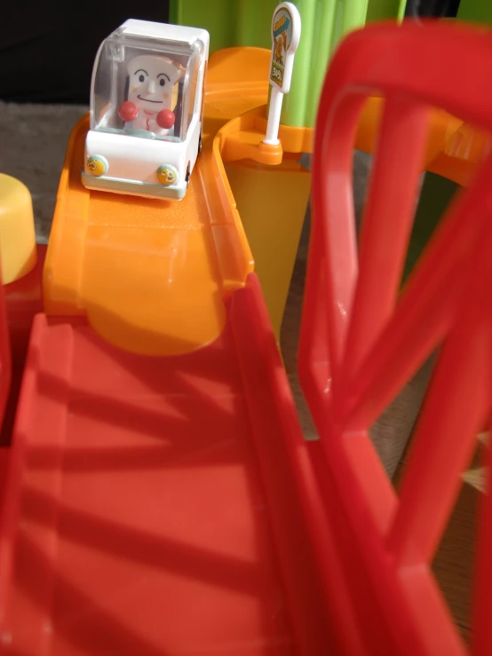 toys sit on an orange plastic table for play