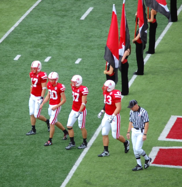 a group of men standing on top of a field