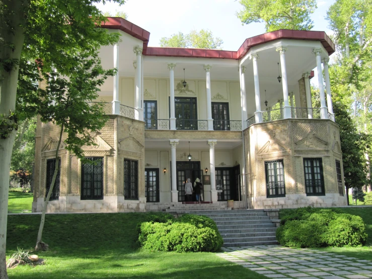 there is a large beige building with two stories