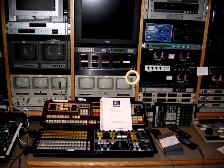 multiple instruments are sitting on a table with some remotes