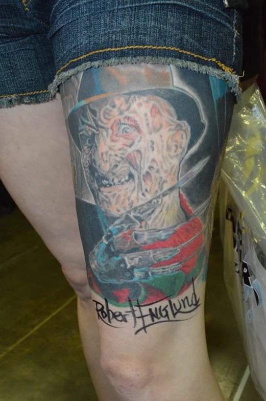 a person with a tattoo on his leg