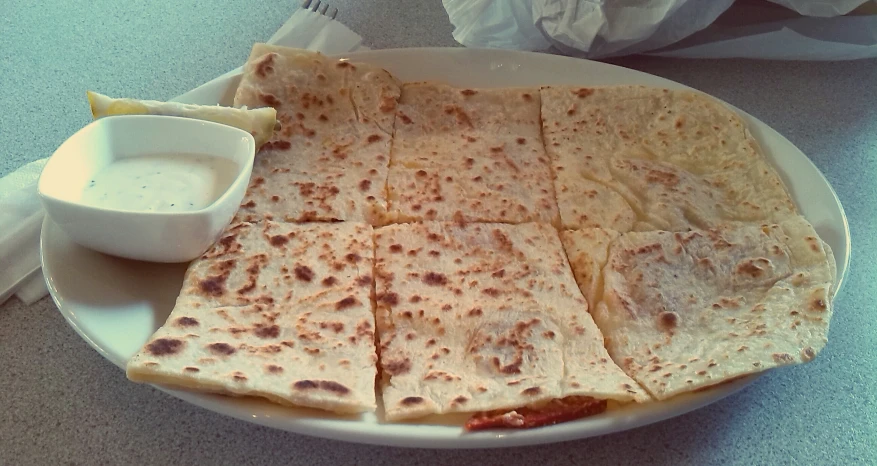 flatbread breads with dip on a white plate