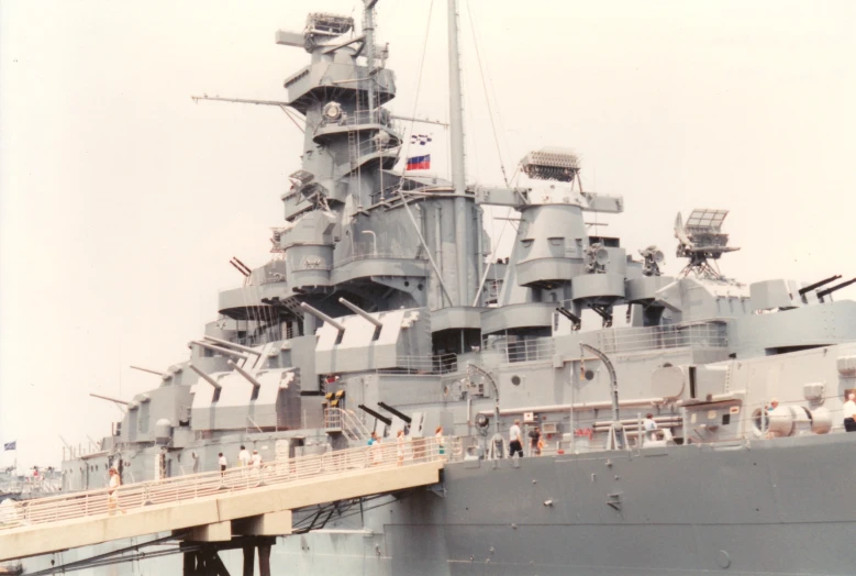 people and boats gathered on deck of navy ship