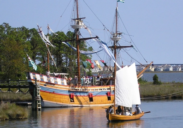 two large boats anchored in the river near each other