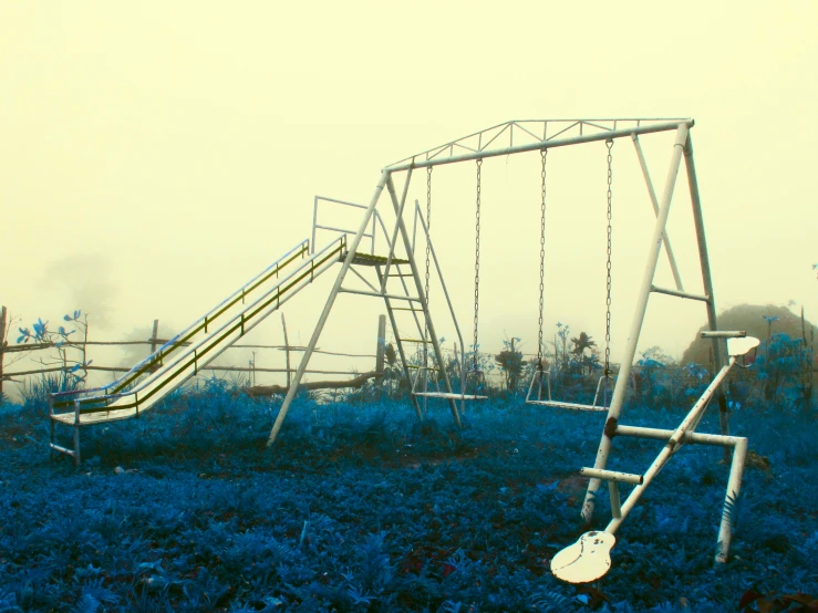 some metal playground equipment in an empty field