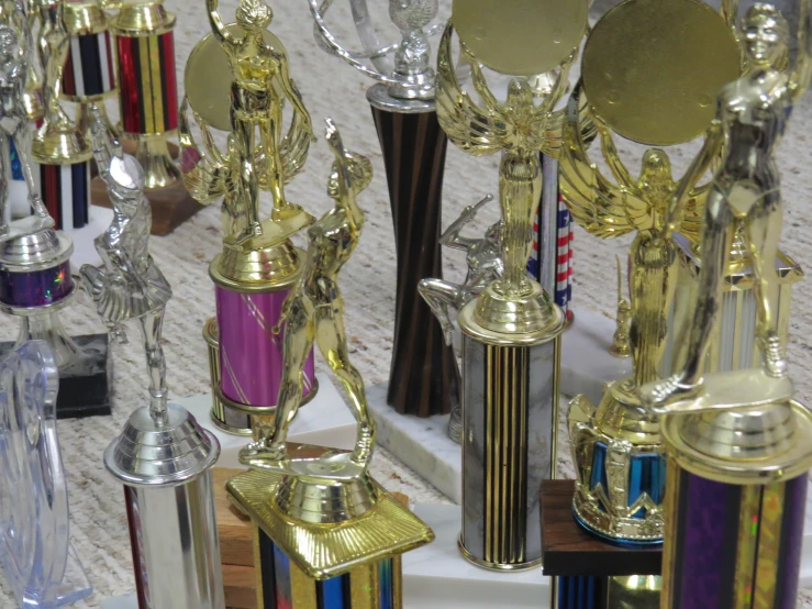 the large group of trophies are all on the table