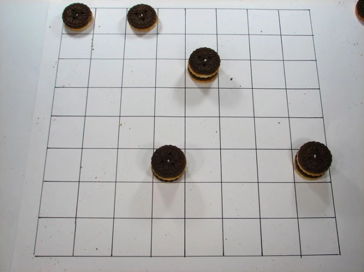 four chocolate doughnuts arranged in a cross -word pattern