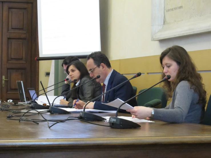 a group of people that are sitting in front of a microphone