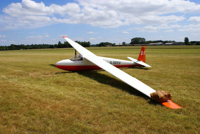 a airplane on a field with another plane upside down