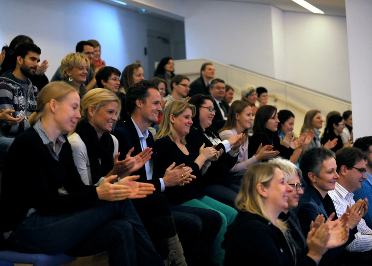 there are many people seated in front of a lecture hall