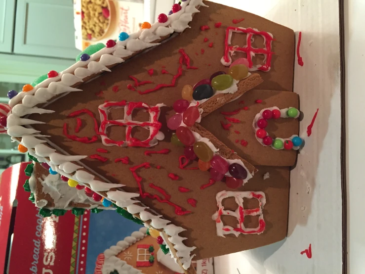 a gingerbread house with sprinkles and candies on the outside