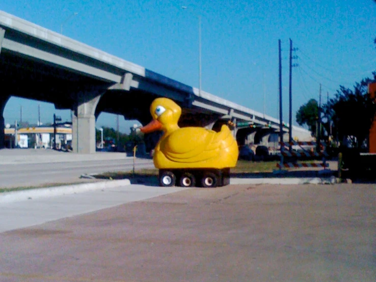 an inflatable ducky sitting in the middle of a sidewalk