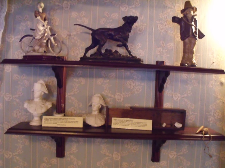 a wall display featuring figurines of dogs and men