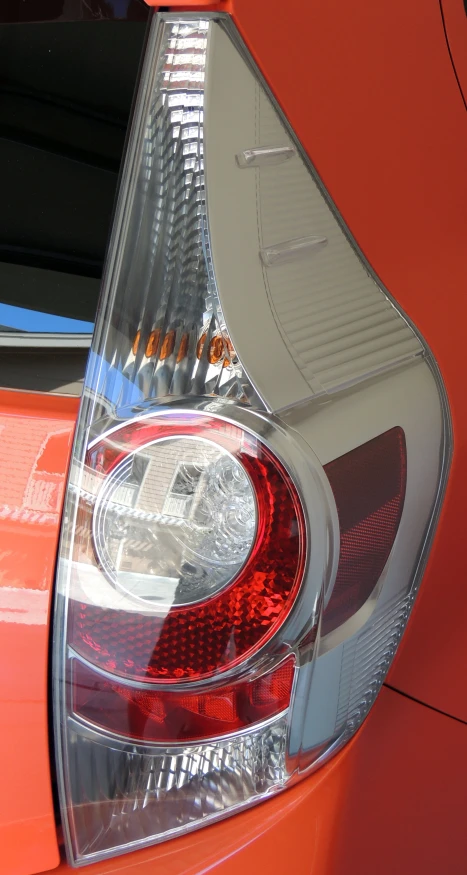 a close - up of the tail lights on an orange sports car