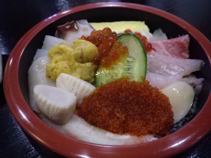 a bowl filled with meat and vegetables on top of a table