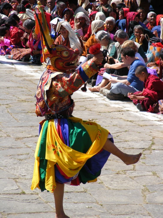 people are watching an oriental dancer in front of a crowd