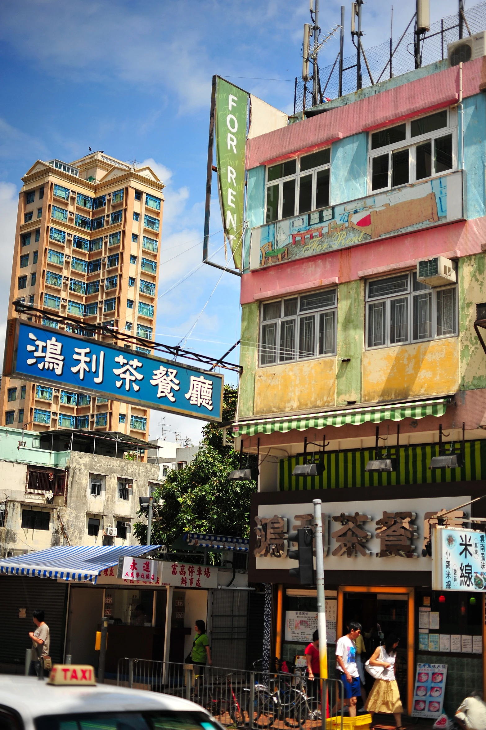 the buildings are colorful with a blue street sign