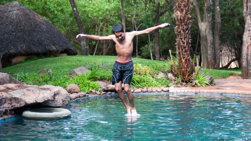 a man on the edge of the swimming pool