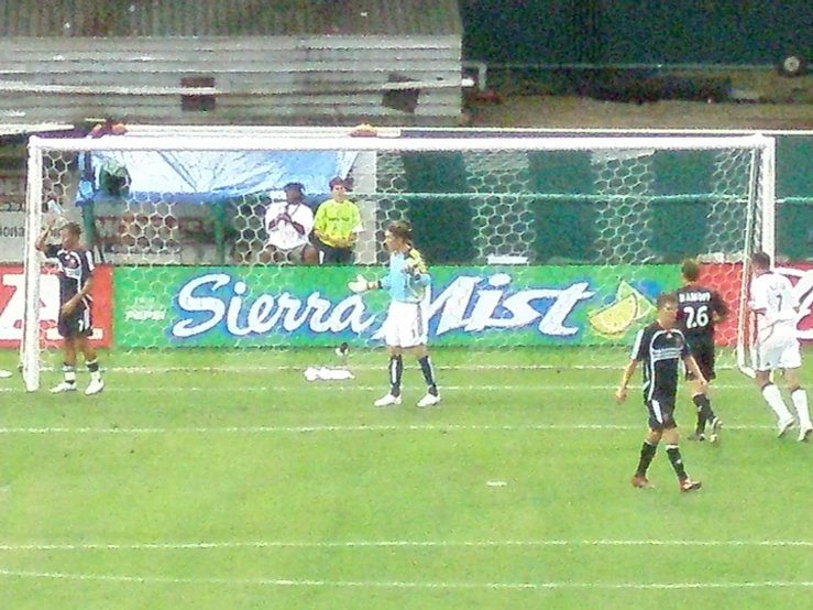 a group of soccer players playing soccer on a field