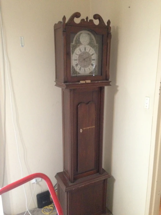 an antique grandfather clock is in the corner