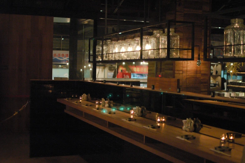 a dimly lit, empty bar with candles on tables