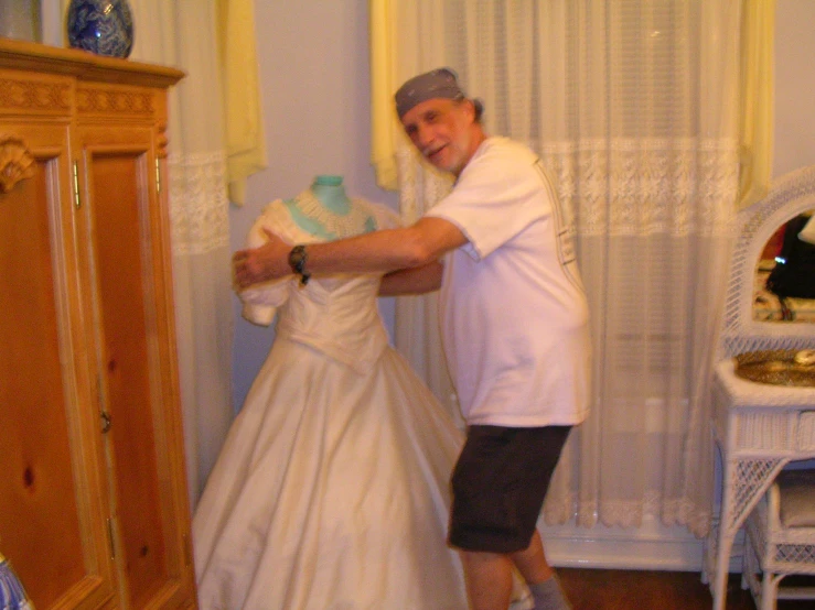 a man and woman who are dressed up in wedding gowns