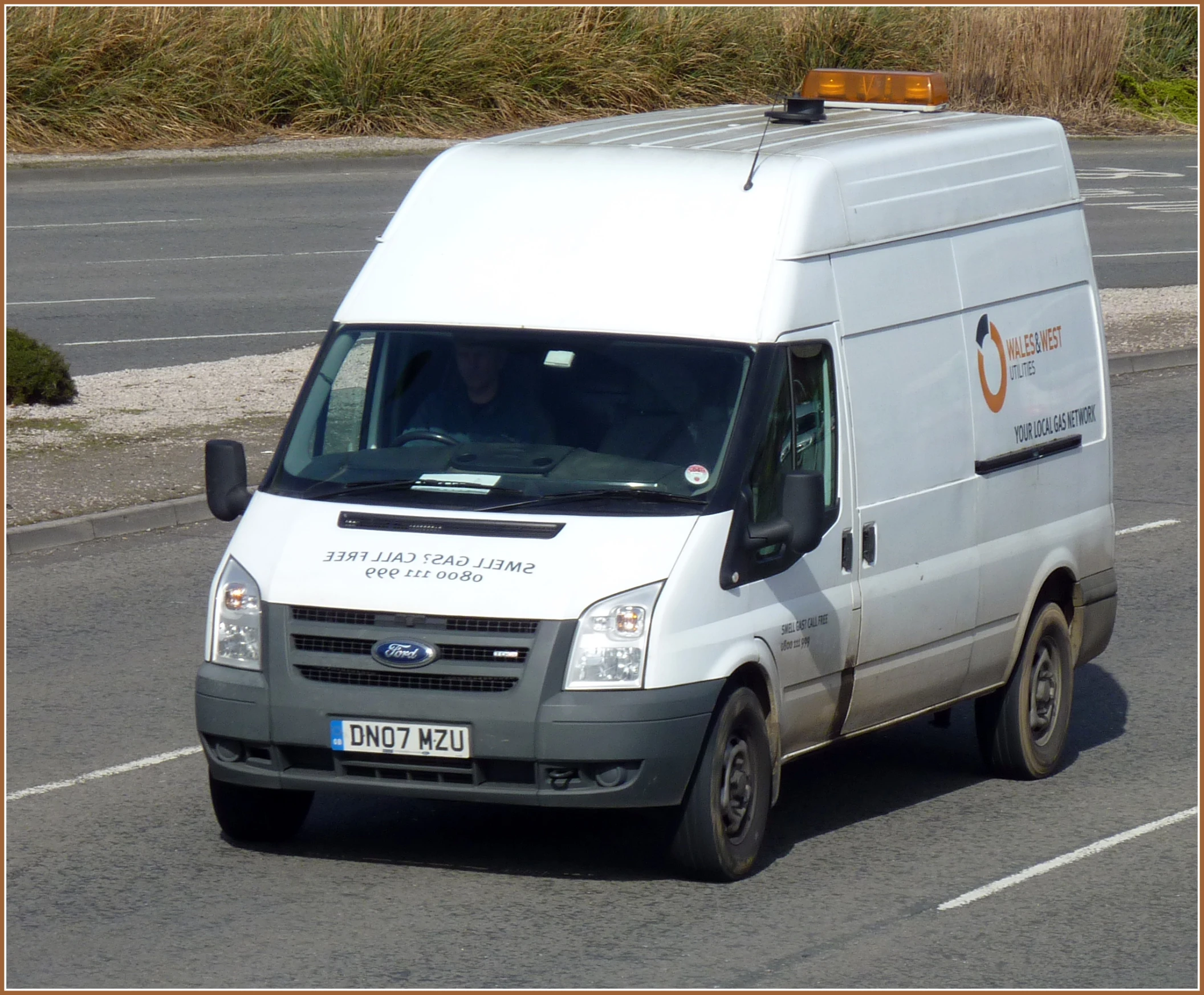 a van driving down the road in front of other traffic