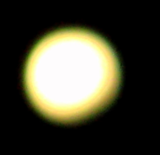 a bright yellow ball of light against a black background