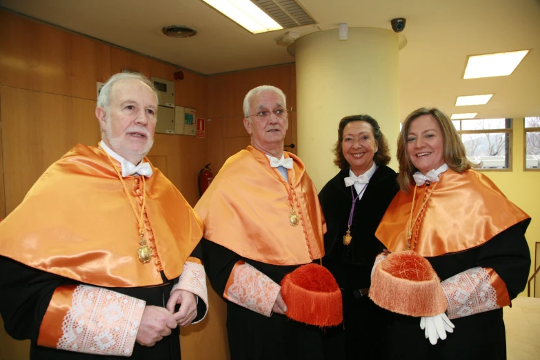 three people dressed in colorful robes posing for a po