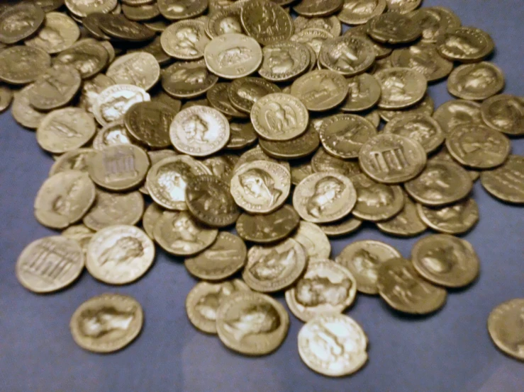 a pile of silver coins on a table