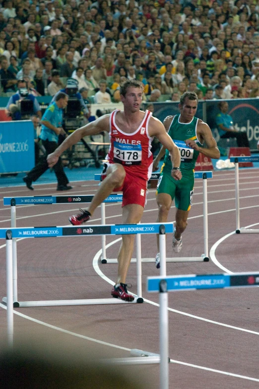 a man in red running on top of a track