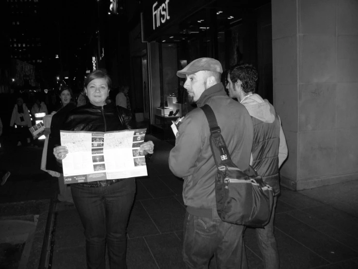 a black and white picture shows two people looking at soing