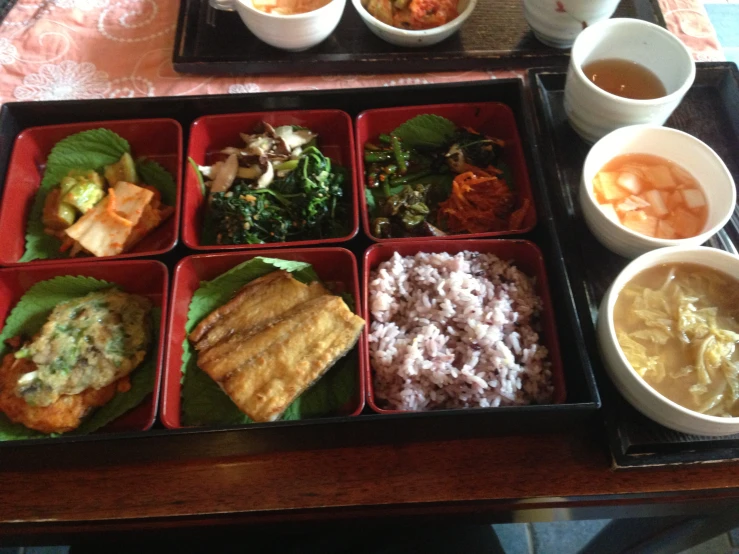 various dishes displayed with drinks in containers on a table