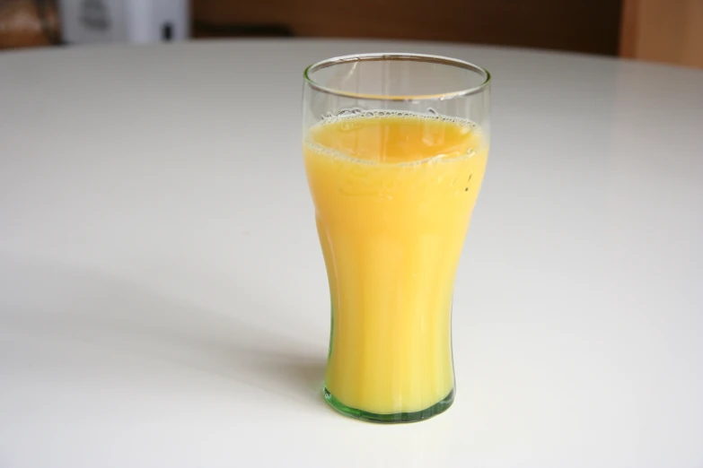 an orange liquid in a glass of orange juice