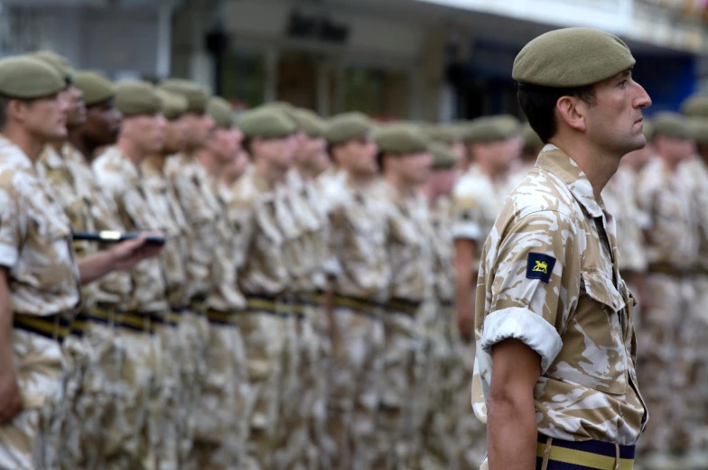 many uniformed men are lined up near each other