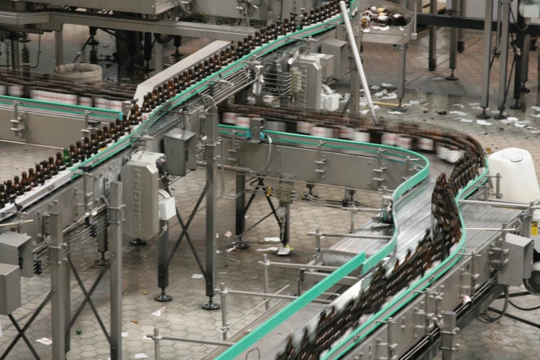 a large factory with rows of bottles connected to conveyor belts