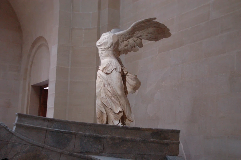 the statue of an angel is in a large room