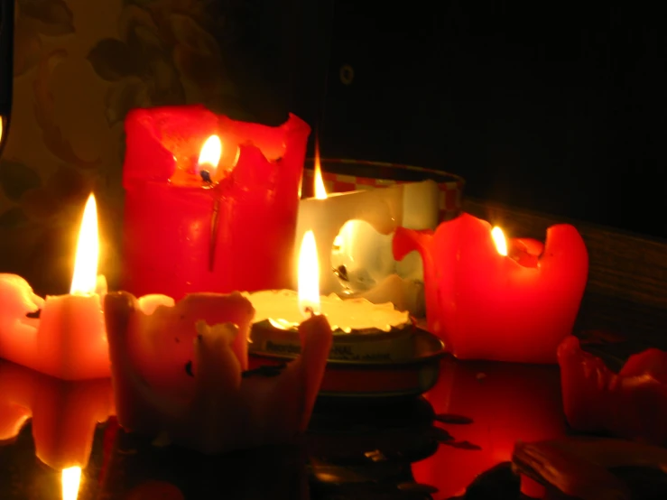 candles with red wax in the middle on a table