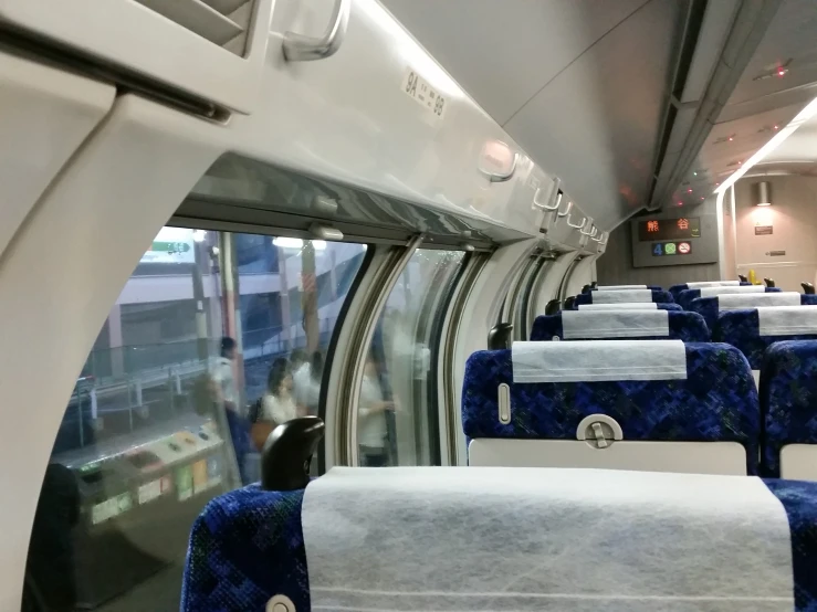 a train with lots of windows and blue seats