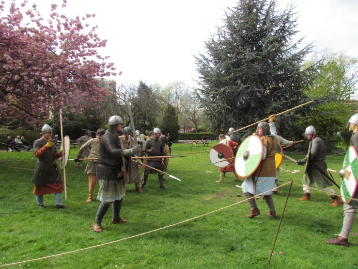 several men dressed in medieval style armor with spears and shields