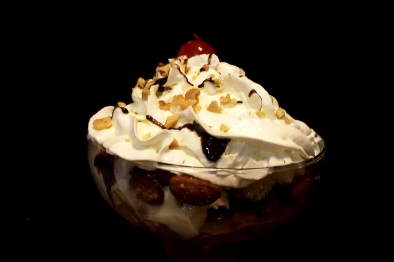 an ice cream sundae with nuts and cherries on top