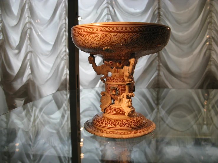 an ornate glass table with fancy decorations on it