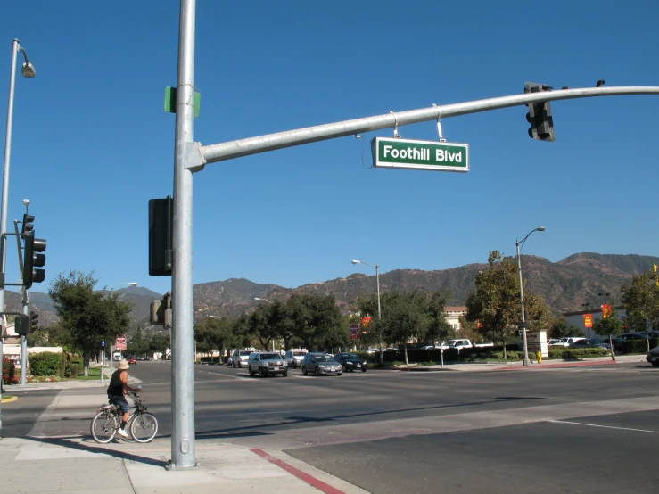 a person on a bicycle that is at a corner