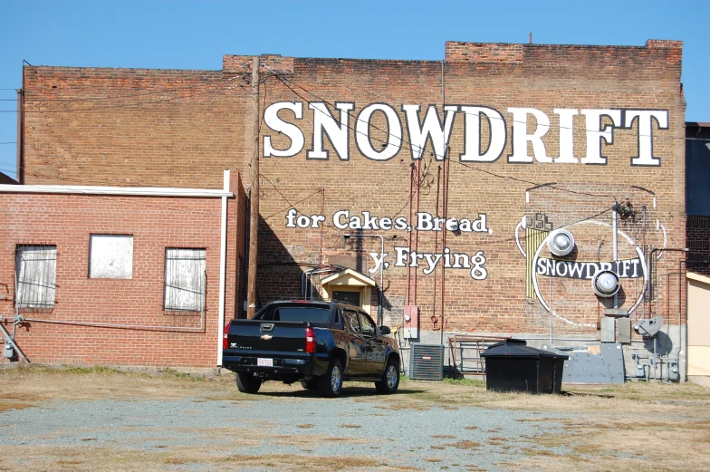 an old, faded brick building with a graffiti covered wall