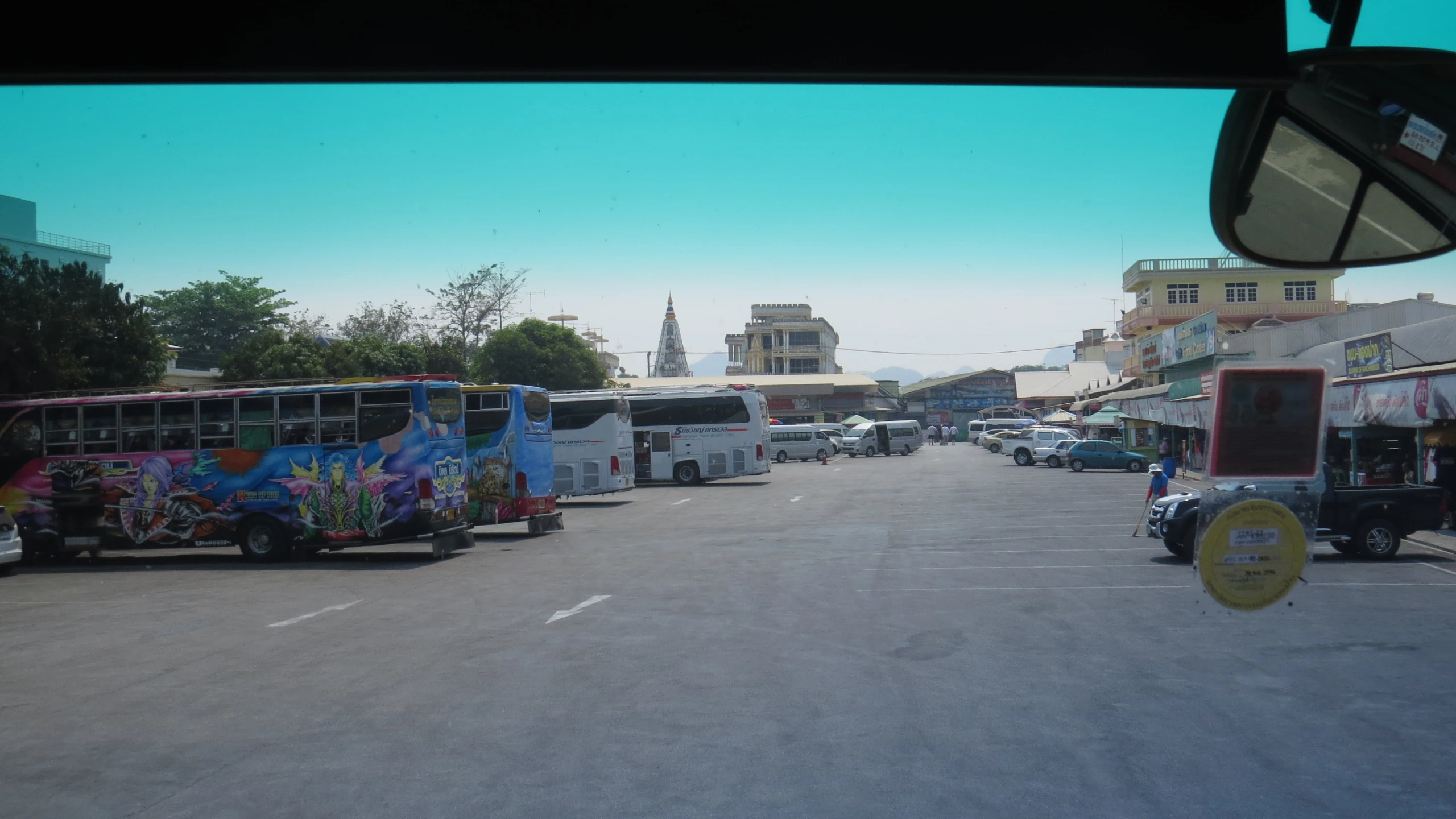 multiple types of city buses are on the street