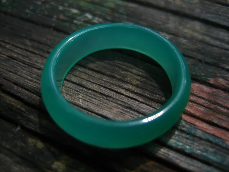 a green ring that is sitting on a table