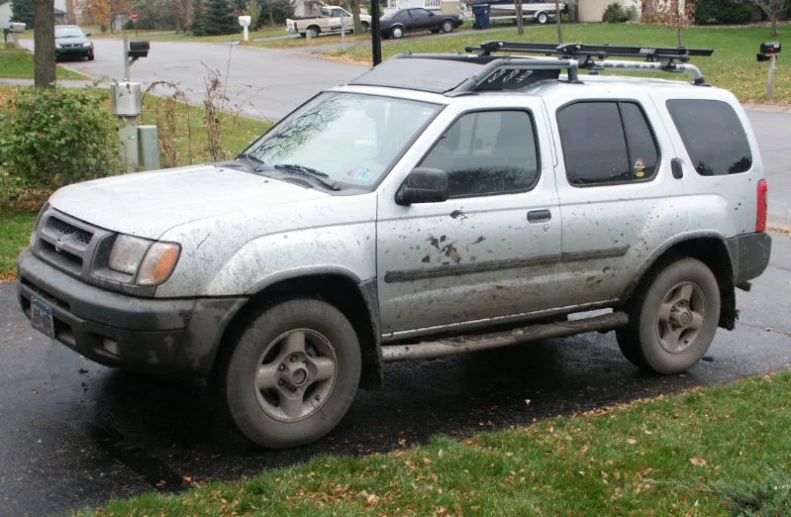 a truck with a bunch of mud on it in the rain
