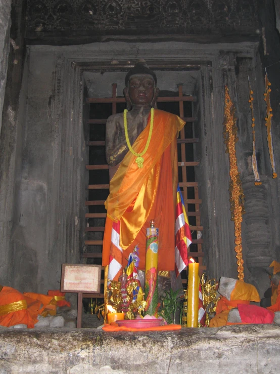 a statue is surrounded by decorative decorations and candles