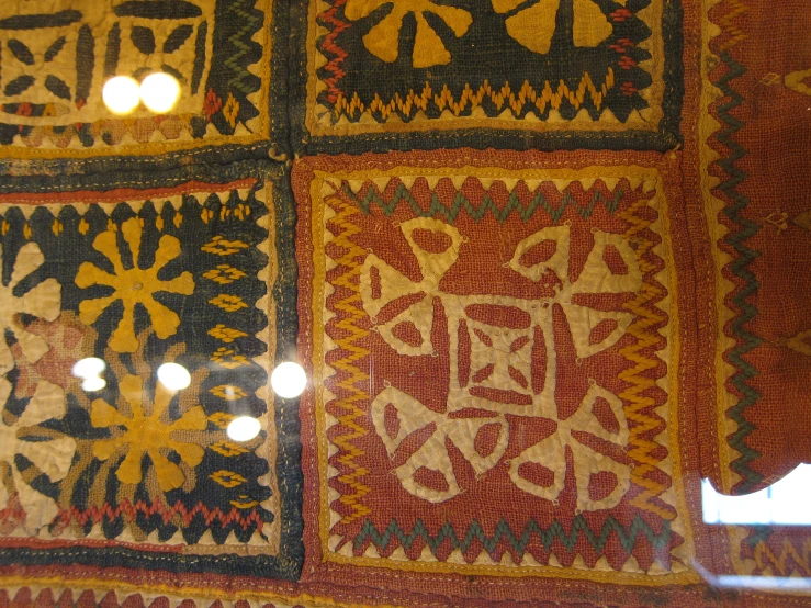 the surface of a mosaic with many decorative designs