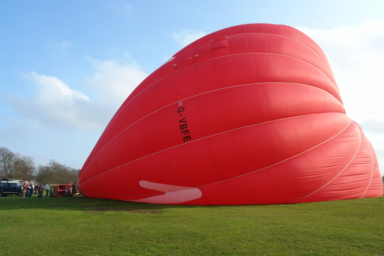 a giant red airplane sitting in the grass